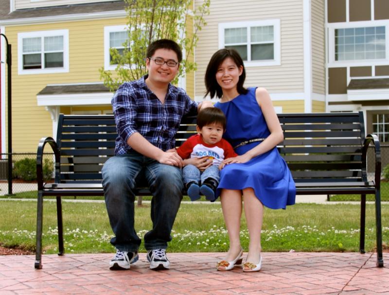 Family sitting on a bench near a playground